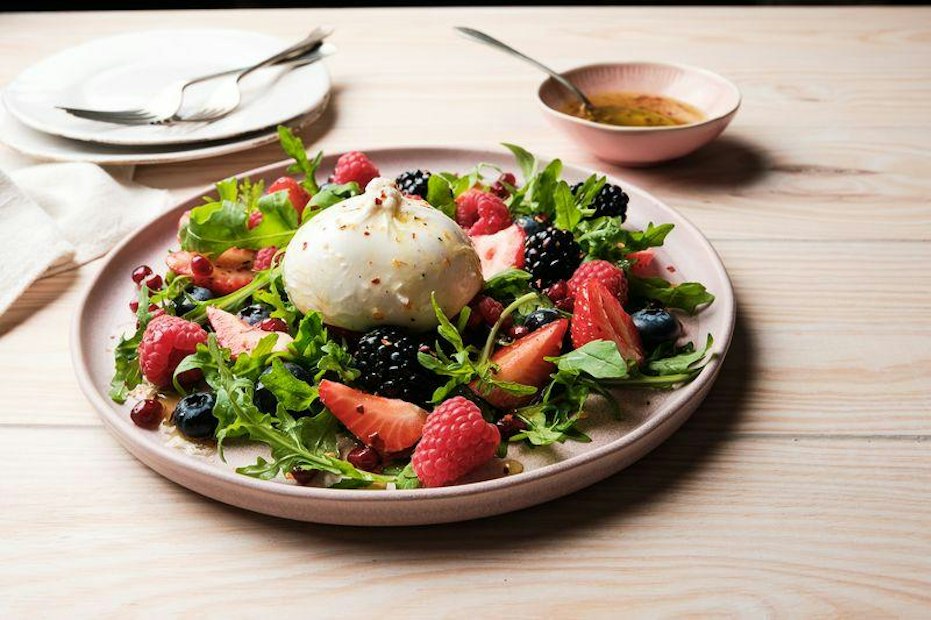 ViewBurrata and berry salad with rocket, pomegranate and hot honey vinaigrette