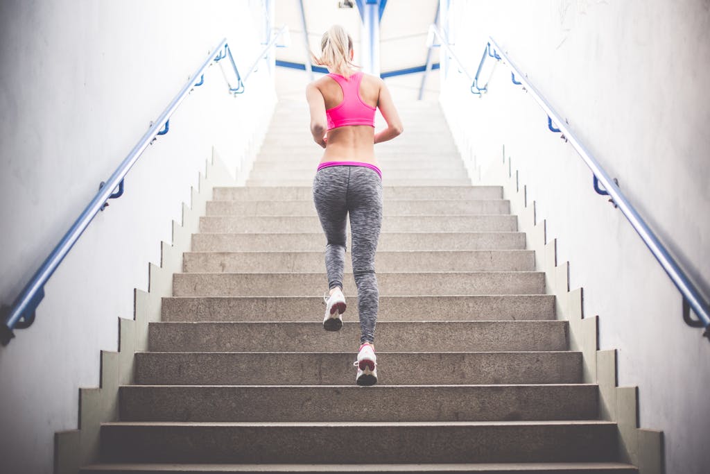 Young fitness girl running up the stairs picjumbo com 75e5vdh8k
